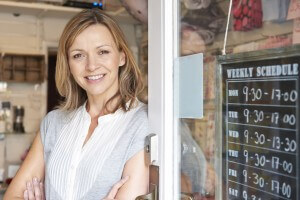 Owner Of Gift Shop Standing In Doorway